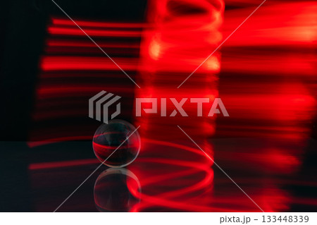 Abstract colorful irregular lines with glass bubble on black background and wall texture. Long exposure. Light painting photography. 133448339