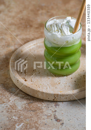 Matcha latte glass, matcha bowl, a bamboo whisk Chasen on travertine tray Matcha latte glass, matcha bowl, a bamboo whisk Chasen on travertine tray 133448389