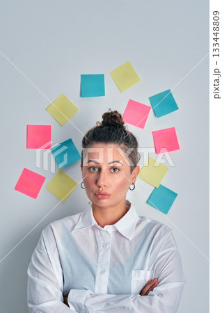 Woman brainstorming ideas with colorful sticky notes 133448809