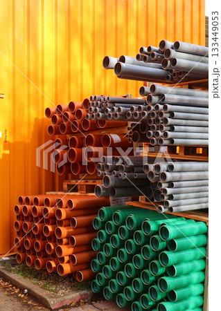 Colorful PVC pipes stacked in an industrial setting 133449053