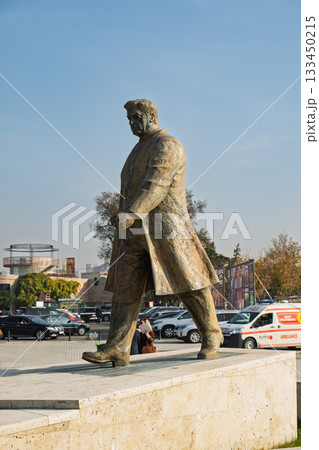 A statue of a man walking on a sidewalk A statue of a man walking on a sidewalk 133450215