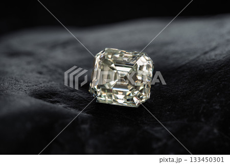 A large diamond is sitting on a black velvet surface A large diamond is sitting on a black velvet surface 133450301