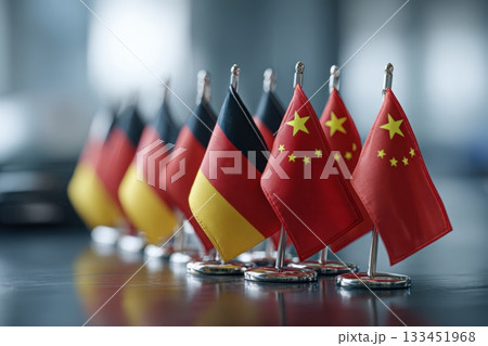 Germany and China Mini Flags on Podium in Diplomatic Conference Setting 133451968