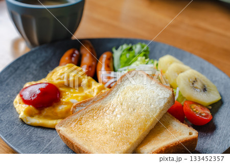 トーストとスクランブルエッグ、ソーセージの洋風朝食プレート 133452357