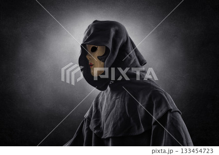 Scary lady with hooded cloak in the dark Scary lady with hooded cloak in the dark 133454723