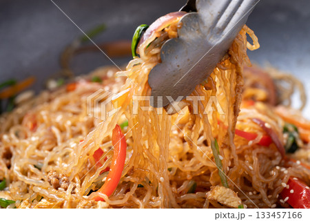 Japchae, Korean stir fried glass noodles with vegetables, pork, soy sauce and sesame oil  133457166