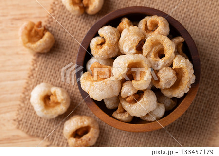 Pork rind in a wooden bowl, Northern Thai food, Table top view Pork rind in a wooden bowl, Northern Thai food, Table top view 133457179