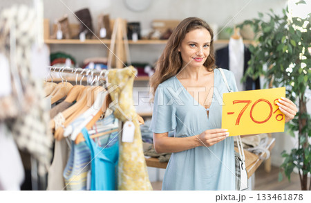 Woman holding poster with 70 percent discount Woman holding poster with 70 percent discount 133461878