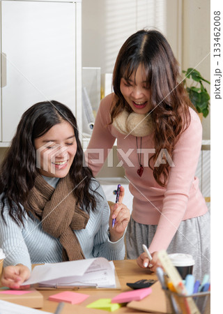 Young businesswomen busy meet people for office financial work, consult team business, collaborate on papers, sharing ideas, productive work environment. 133462008