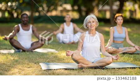 Yoga for people of different ages - elderly woman practicing different yoga poses together in park Yoga for people of different ages - elderly woman practicing different yoga poses together in park 133462188