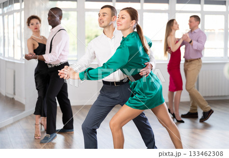 Woman and young man practicing waltz in dancing studio Woman and young man practicing waltz in dancing studio 133462308