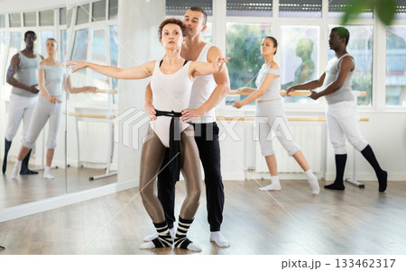 Young man and adult woman rehearsing pair ballet Young man and adult woman rehearsing pair ballet 133462317