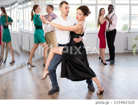 Woman and young man practicing waltz in dancing studio 133462320