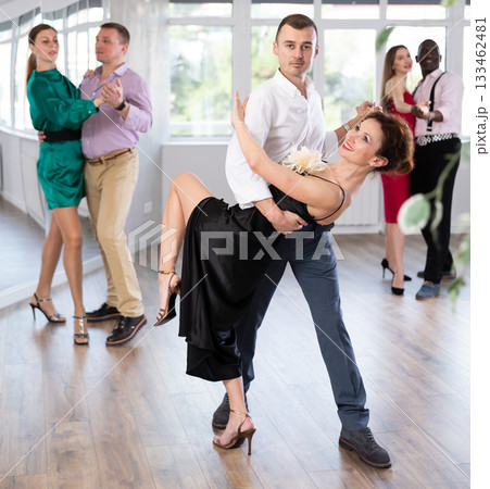 Woman dances incendiary tango with man partner during choreography lesson Woman dances incendiary tango with man partner during choreography lesson 133462481