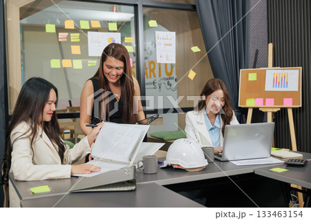 Business women meet, busy team people work on project meeting, three young women collaborating, discussing strategy, planning future company growth in modern office. Business women meet, busy team people work on project meeting, three young women collaborating, discussing strategy, planning future company growth in modern office. 133463154