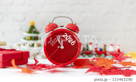 2025 and 2026 on red alarm clock on Christmas item background 2025 and 2026 on red alarm clock on Christmas item background 133463290