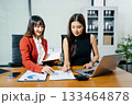 Business portrait two woman asian  smile cheerful talk and holding tablet, computer with in agreement ready new project job for work in room office 133464878