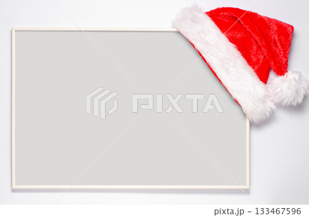 An empty record frame with a Santa hat. The concept of planning for the new year. An empty record frame with a Santa hat. The concept of planning for the new year. 133467596