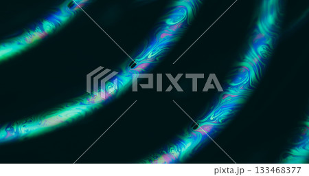 Defocused light fluid. Gasoline emulsion. Green blue purple color ink curve bubble neon rainbow texture floating on abstract dark black background. Defocused light fluid. Gasoline emulsion. Green blue purple color ink curve bubble neon rainbow texture floating on abstract dark black background. 133468377