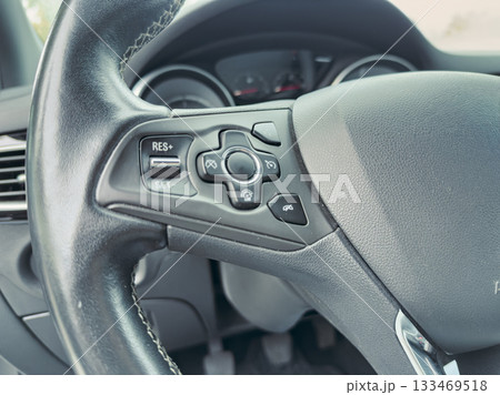 Exploring the features of a modern steering wheel with intricate controls for enhanced driving experience and convenience 133469518