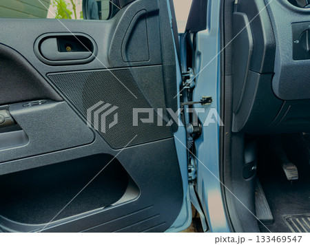 Intricate details of a car door interior showcase craftsmanship and functionality in a well-lit parking area during daylight hours Intricate details of a car door interior showcase craftsmanship and functionality in a well-lit parking area during daylight hours 133469547