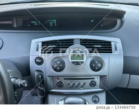 Dashboard display of a car showing the odometer reading and temperature during a sunny day drive Dashboard display of a car showing the odometer reading and temperature during a sunny day drive 133469730