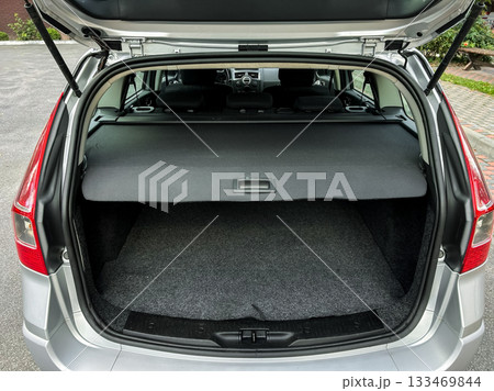 Spacious trunk of a sleek silver vehicle ready for adventure and road trips in a quiet parking lot on a sunny afternoon Spacious trunk of a sleek silver vehicle ready for adventure and road trips in a quiet parking lot on a sunny afternoon 133469844