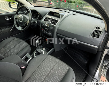 Interior view of a modern car showing sleek design and practical features in a cozy urban setting during daylight Interior view of a modern car showing sleek design and practical features in a cozy urban setting during daylight 133469846