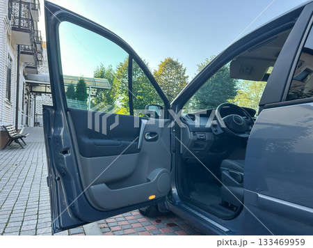 Beautiful morning scene with a car door open in an inviting urban setting showcasing greenery and a well-paved pathway Beautiful morning scene with a car door open in an inviting urban setting showcasing greenery and a well-paved pathway 133469959