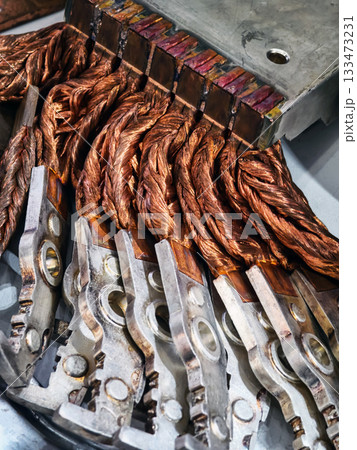 Detailed view of copper wiring and metal connectors in industrial machinery at a manufacturing plant Detailed view of copper wiring and metal connectors in industrial machinery at a manufacturing plant 133473231