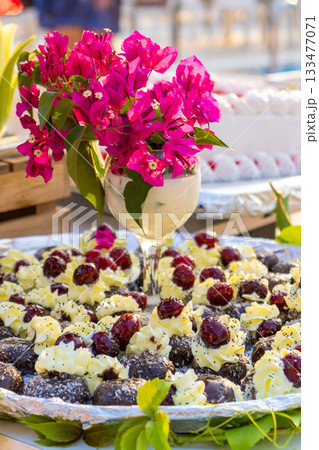 Cherry Desserts with Cream and Pink Flowers in Elegant Glass Luxury Catering Setup 133477071