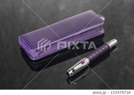 A branded fountain pen next to a box. Gift set. Selective focus. Office interior 133478716