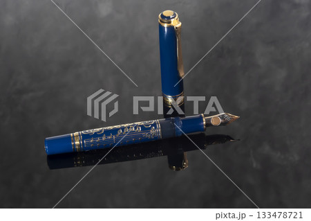 A branded fountain pen next to a box. Gift set. Selective focus. Office interior 133478721
