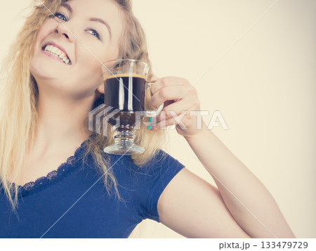 Positive woman drinking her morning coffee 133479729