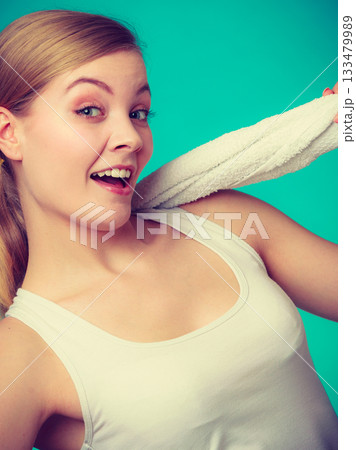 Woman with a towel around her shoulders smiling 133479989