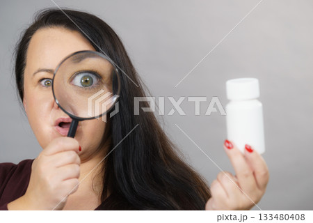 Woman investigating ingredients of medicines 133480408