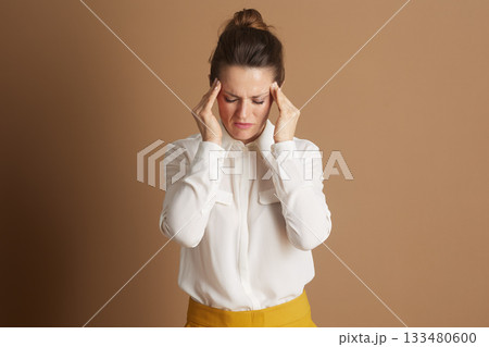 Woman in Yellow Skirt with Stress Headache Woman in Yellow Skirt with Stress Headache 133480600