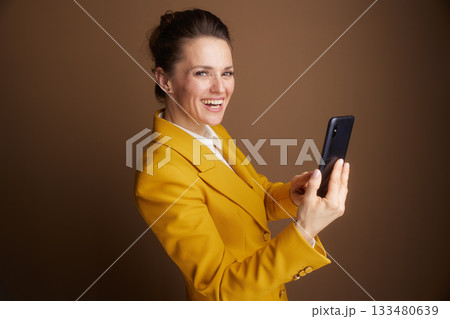 Smiling Business Professional Holding Smartphone Smiling Business Professional Holding Smartphone 133480639
