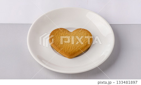 Heart shaped cookies on a minimalist white plate. Heart shaped cookies on a minimalist white plate. 133481897