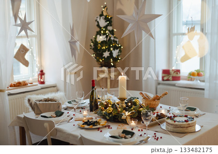 A table set for dinner meal at Christmas time. A table set for dinner meal at Christmas time. 133482175