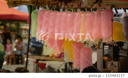 Vibrant colored cotton candy bags hang from a food stand at the weekend market in Valencia, Negros Oriental, Philippines Vibrant colored cotton candy bags hang from a food stand at the weekend market in Valencia, Negros Oriental, Philippines 133483137