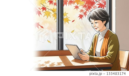 穏やかな秋の日差しに包まれてタブレット操作 133483174