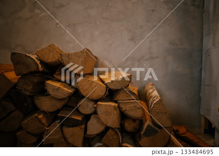 Stack of Firewood Against Rustic Wall Stack of Firewood Against Rustic Wall 133484695