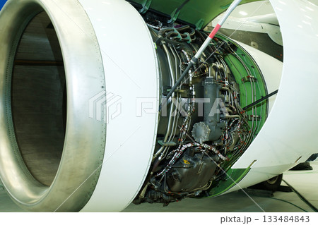 Detailed view of an aircraft engine showcasing intricate components and mechanical design in an aviation workshop environment 133484843