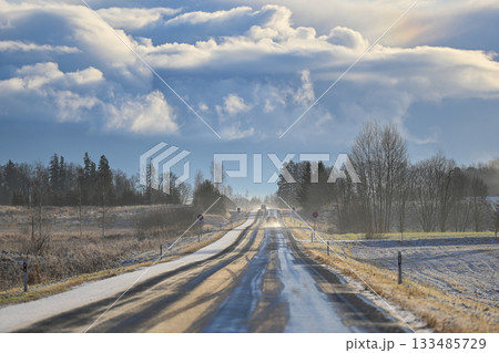 Icy Winter Road Under Sculpted Clouds in Latvia Icy Winter Road Under Sculpted Clouds in Latvia 133485729