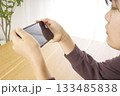 自宅でスマートフォンを使う女性 133485838