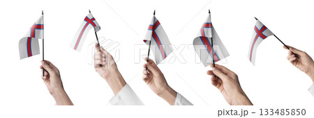 The Faroe Islands flag in hand in different angles on a white background 133485850