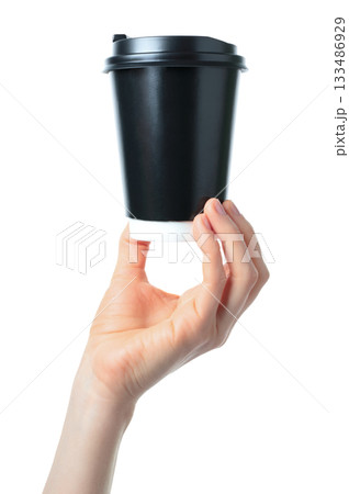 Hand holding a black kraft coffee cup. Clean studio lighting, texture, isolated on transparent background. Perfect for branding, packaging, and advertising use 133486929