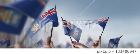 Falkland Islands flags in their hands on a blurred urban background Falkland Islands flags in their hands on a blurred urban background 133486947