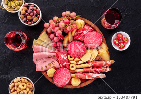 Italian Antipasti. Charcuterie platter with cheese and other snacks, with wine 133487791